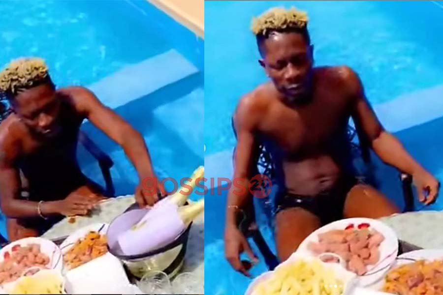 Shatta Wale enjoys lunch in his swimming pool